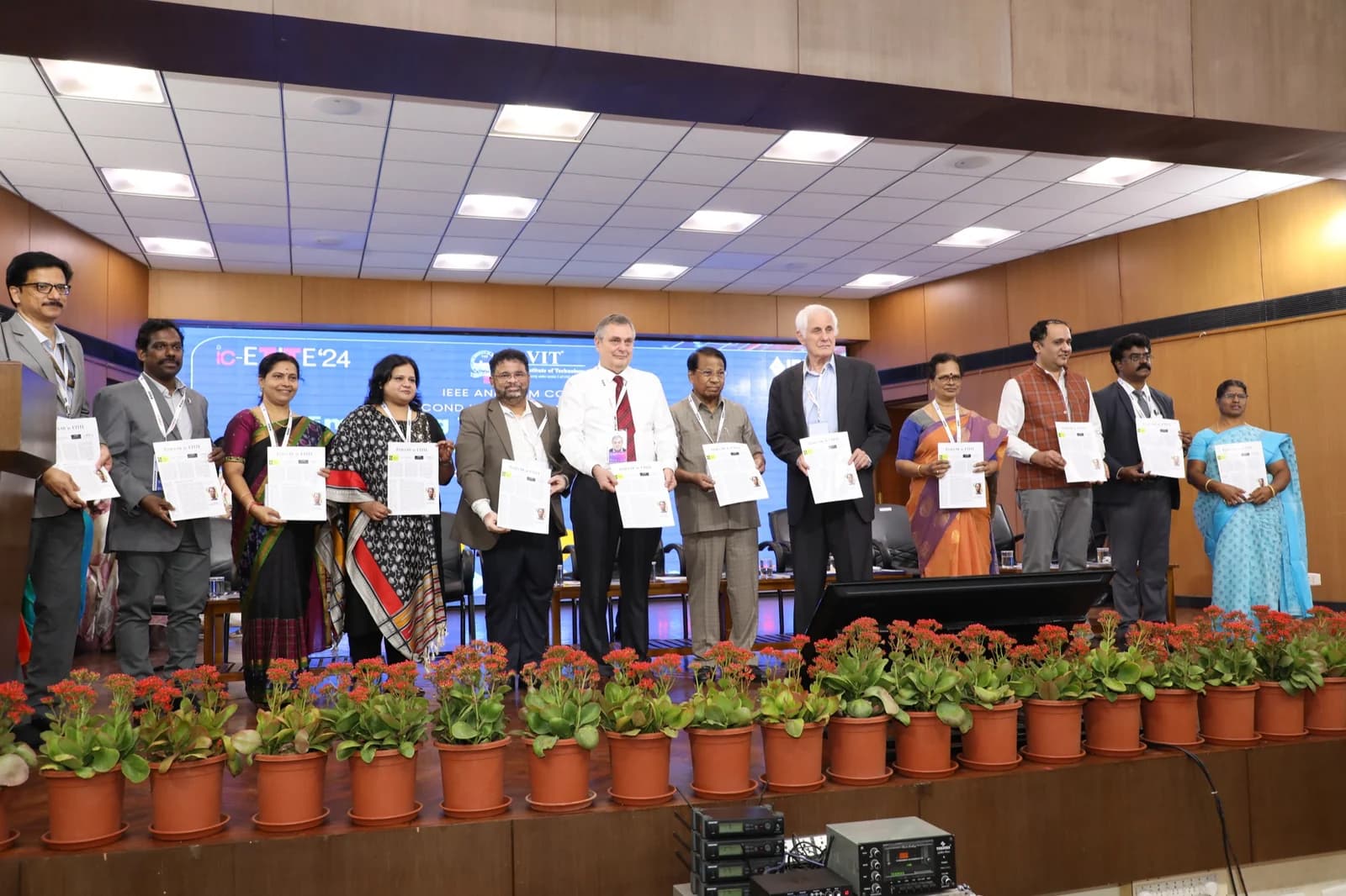 Dignitaries releasing conference proceedings on dais at ic-ETITE International Conference